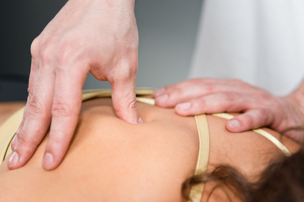 Woman getting a Shiatsu Massage for her back pain in Los Altos.